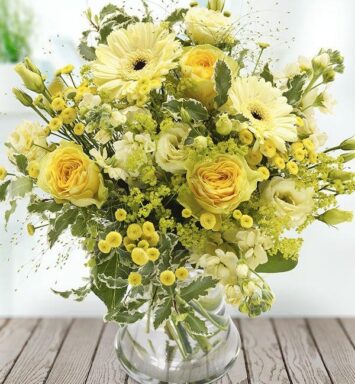 a vase of yellow flowers