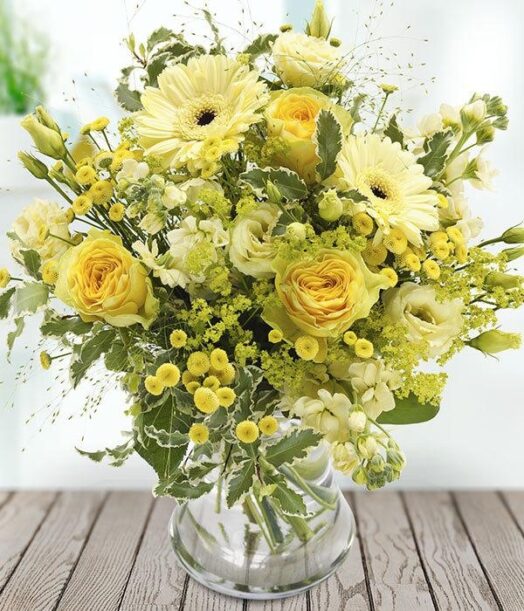 a vase of yellow flowers