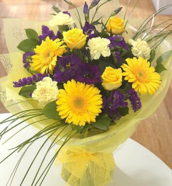 a bouquet of yellow and purple flowers