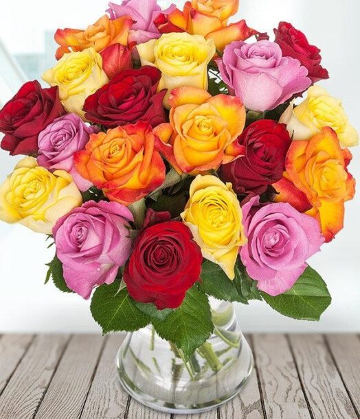 a bouquet of colorful roses in a glass vase